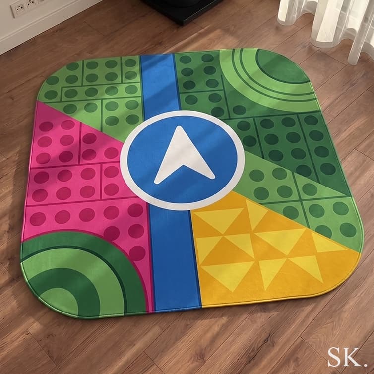 Vibrant geometric area rug with a central blue navigation icon and colorful quadrants resembling a map or game board.
