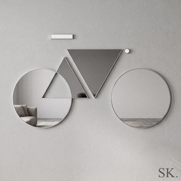 Geometric mirror wall art forming a minimalist bicycle design on a gray wall.